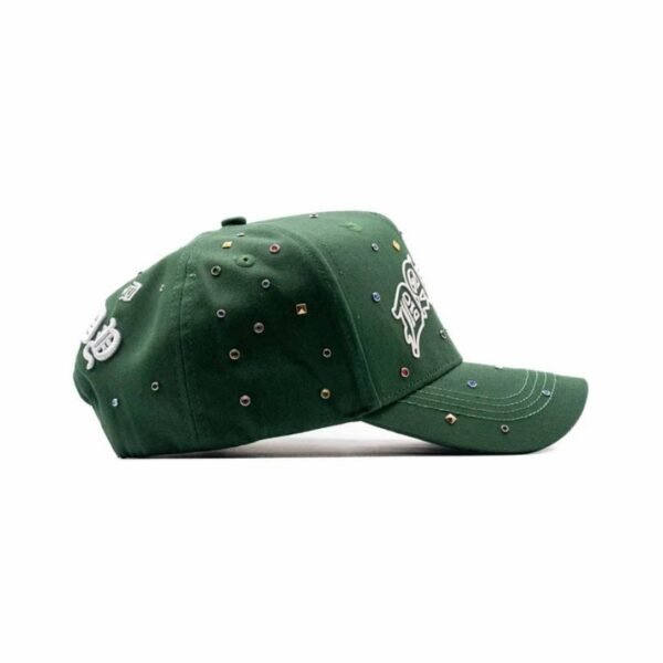 Left Side Profile of Green Cap with Jewels Side profile of green Dandy Hats cap with rhinestones and raised white embroidery on the crown.
