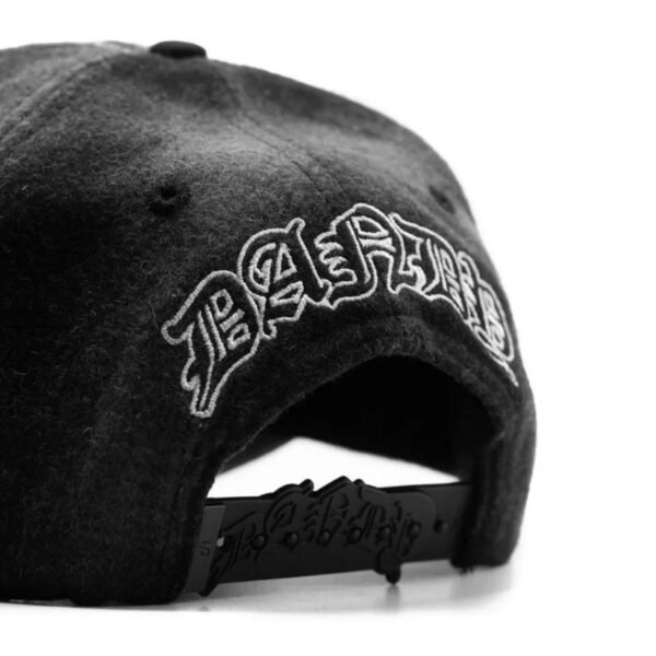 Rear Angle View of pLAid Cap and Strap Angled view showing Dandy embroidery on the back and branded adjustable strap.