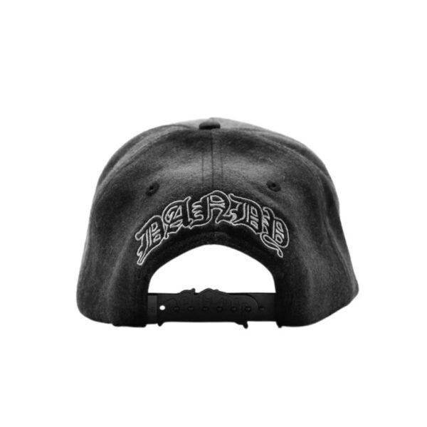 Rear View of pLAid Cap with Dandy Embroidery Back of pLAid cap featuring DANDY text in gothic font above adjustable strap.