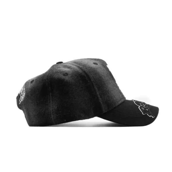 Side Profile of pLAid Black Wool Cap Side view of the pLAid cap showing felt texture and curved brim with embroidered script.