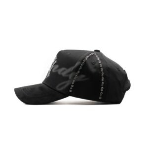 Side view of the oNYx cap showing grommet detailing and embroidered “Dandy” text shadow.